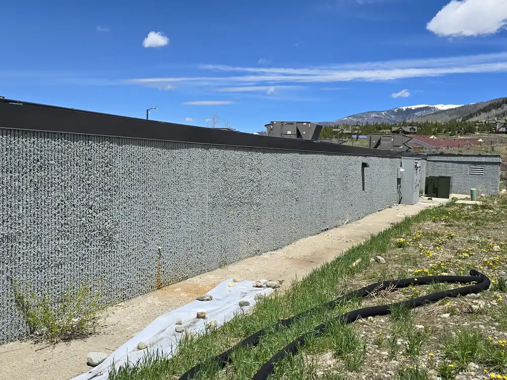 Steep worn access path beside a commercial building