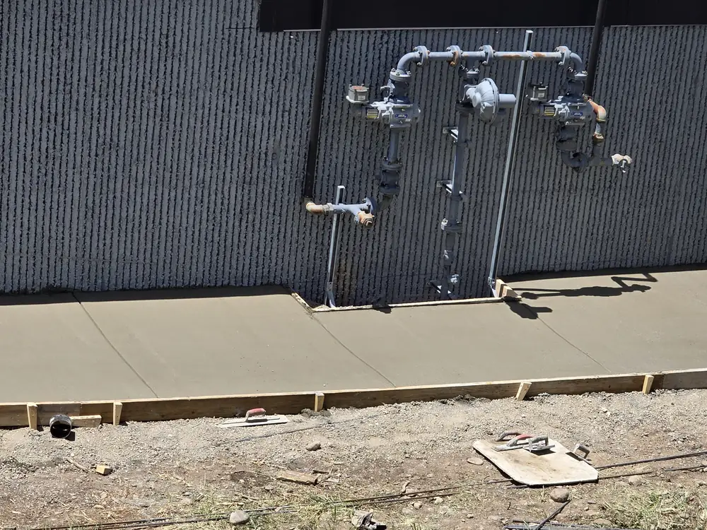 Concrete walkway forms beside a commercial building