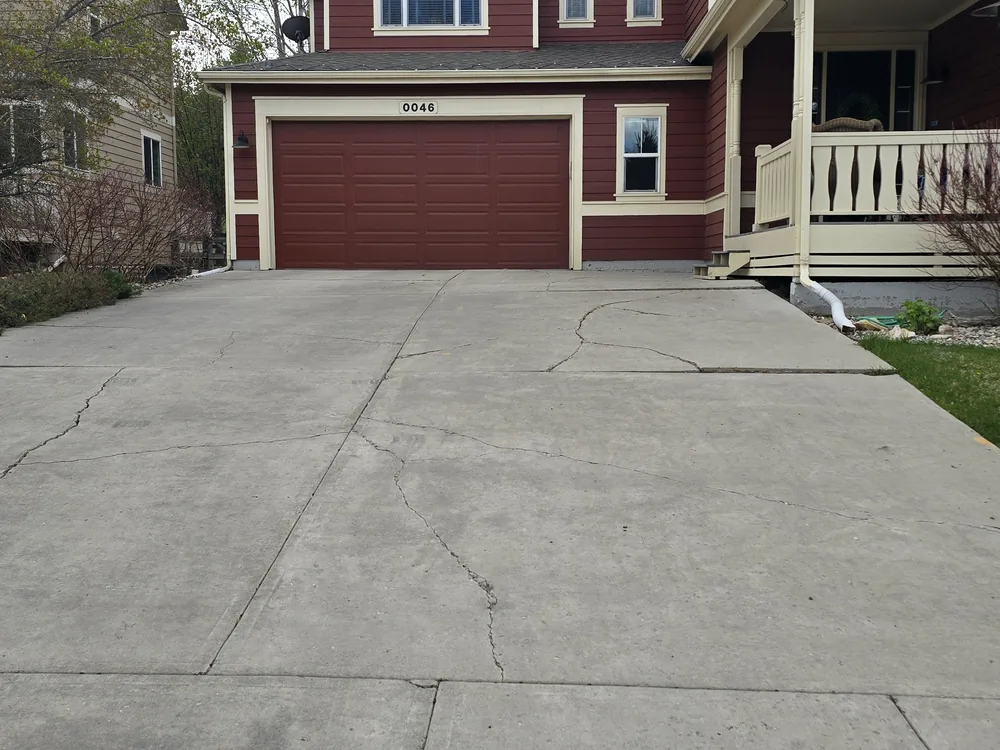 Cracked driveway before replacement in Eagle