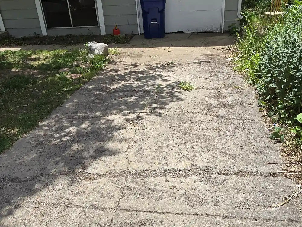 Cracked concrete driveway before repair
