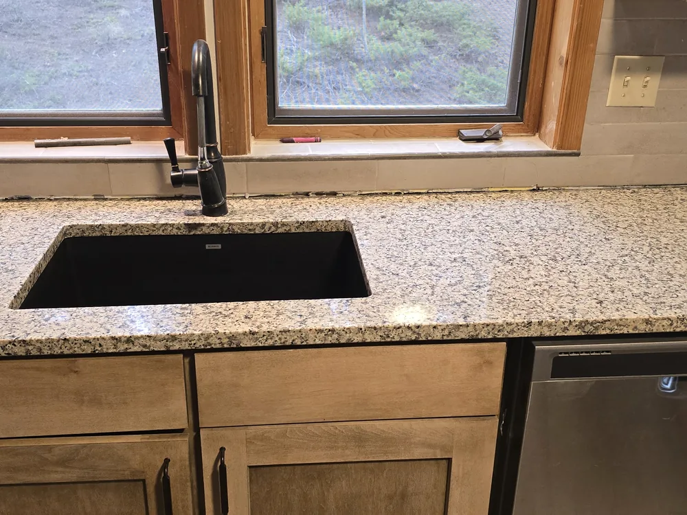 Completed kitchen sink and granite countertops