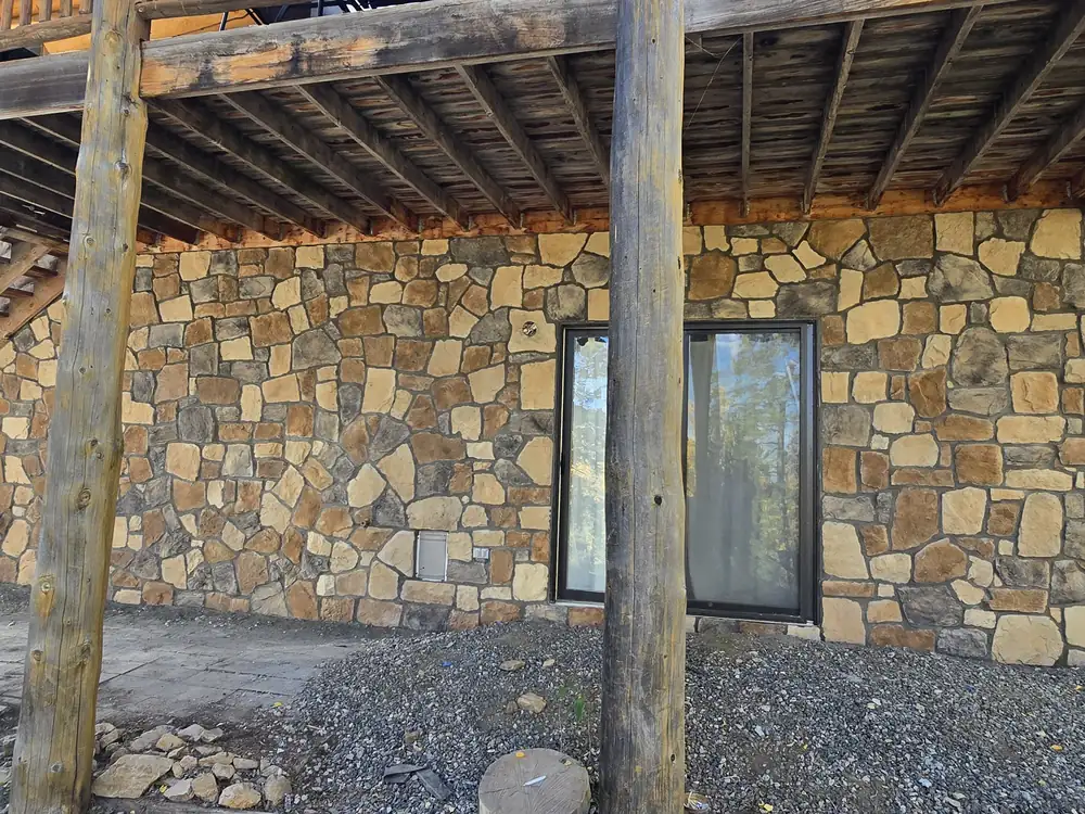 Natural-stone veneer after installation beneath a deck