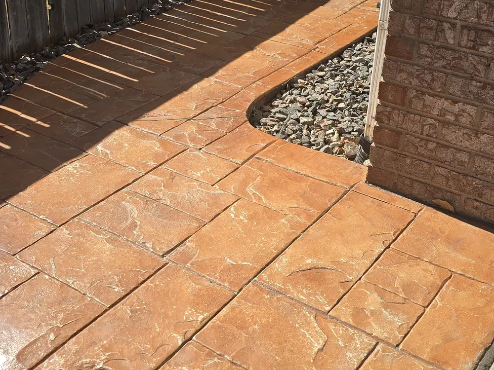 Worn stamped-concrete walkway before restoration